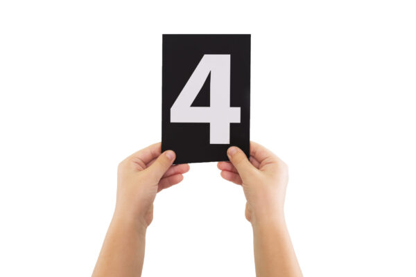 Two,Hands,Are,Holding,A,Black,Paper,Card,With,Number